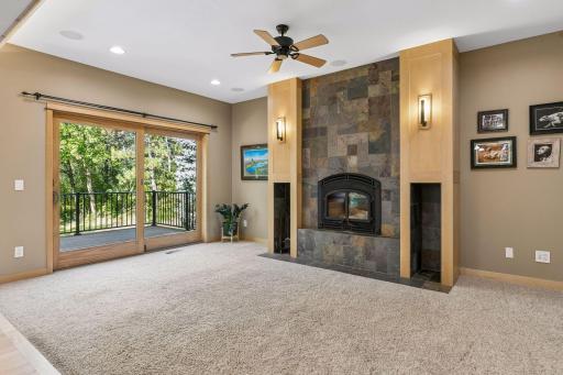 Views of the wooded backyard and access to the cedar deck through this oversized sliding glass door in the living room.