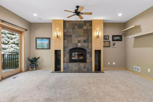 Carpet, ceiling fan in the living room. Andersen Windows throughout home. Maple millwork and solid maple doors throughout.