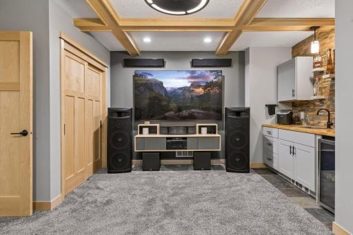 One of the lower-level bedrooms can also serve as an entertainment space with a wet bar and a closet with paneled sliding doors.