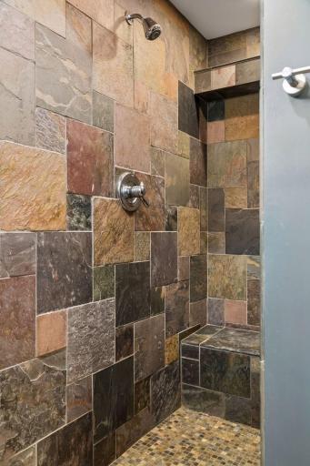 Slate walls and floor in the large walk-in shower.