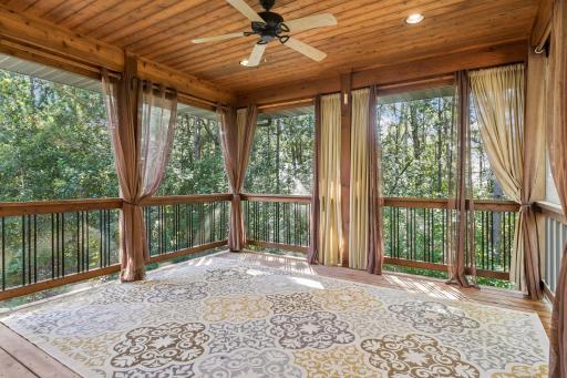The screened porch is like a tree fort, without the bugs. Enjoy nature views from this outdoor living space. Cedar tongue-and-groove ceiling with a fan and recessed lighting.