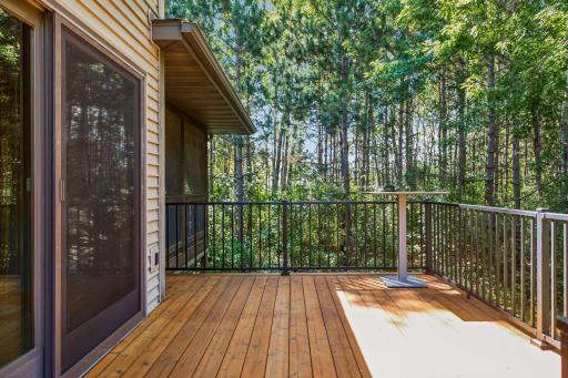 The expansive cedar deck provides views of the private wooded backyard area, railings are maintenance-free aluminum.