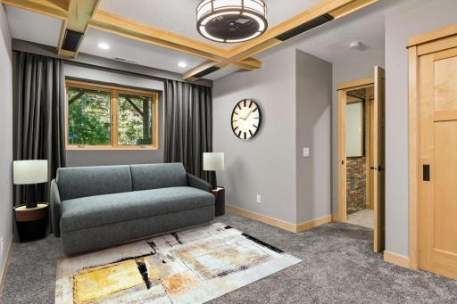 Lower-level bedroom #2 can serve as a bedroom and entertainment room with a pull-out sofa bed. Virtually staged.