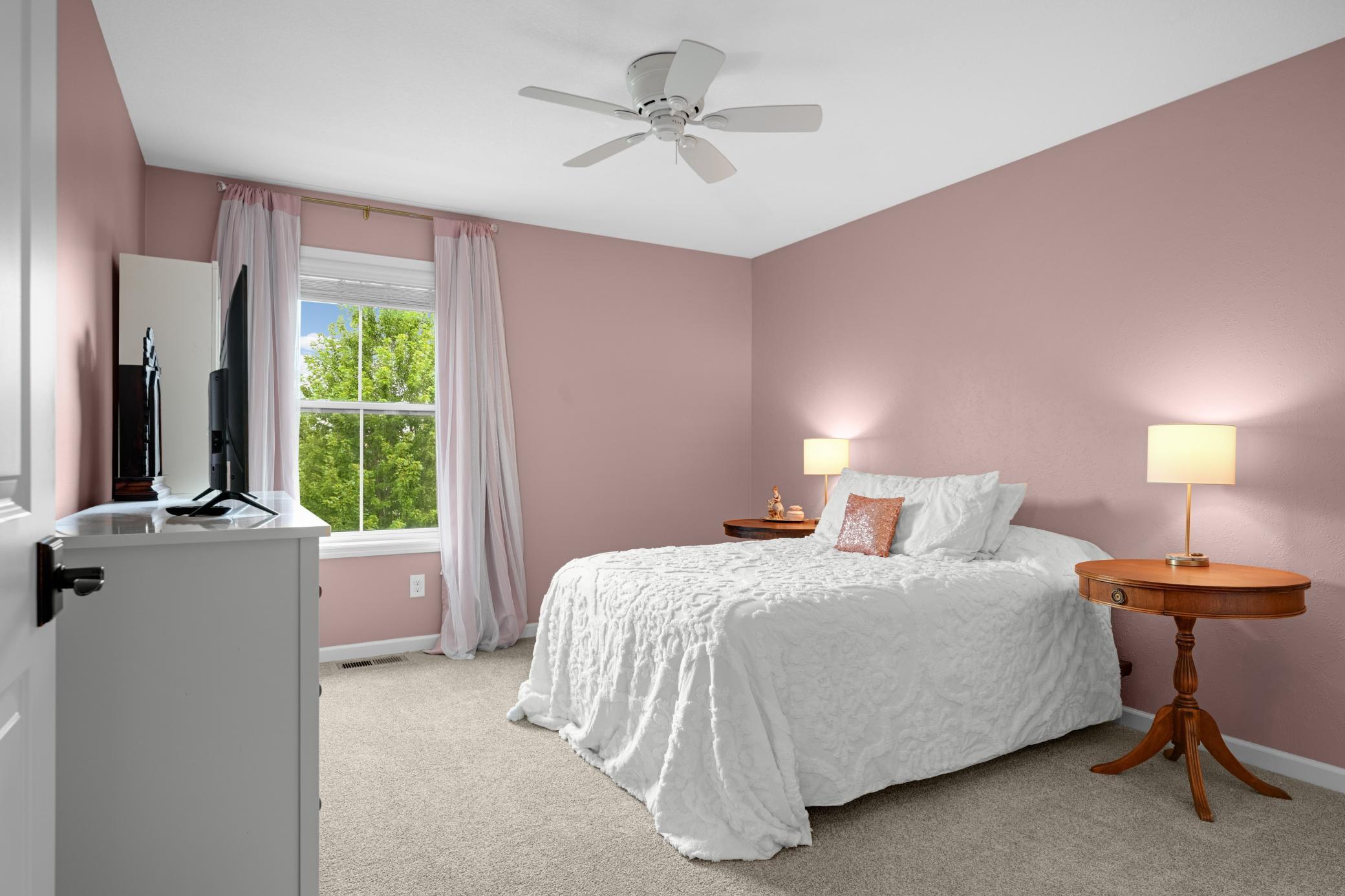 The second bedroom on the upper level also overlooks the backyard.