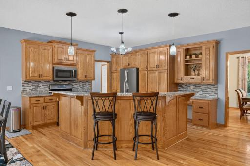 Custom cabinetry, granite island and stainless appliances.