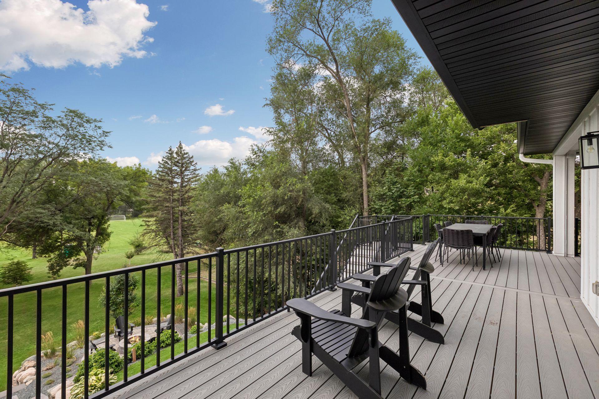 Deck overlooking pretty backyard and park