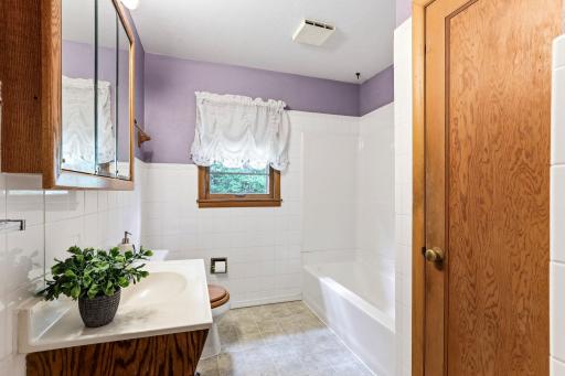 Main floor full bath has updated tub surround and flooring