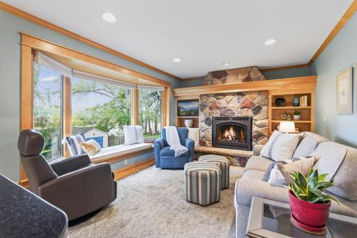 Great window seat, plus outlets hidden by the crown molding above the fireplace make it easy to place lighted decor