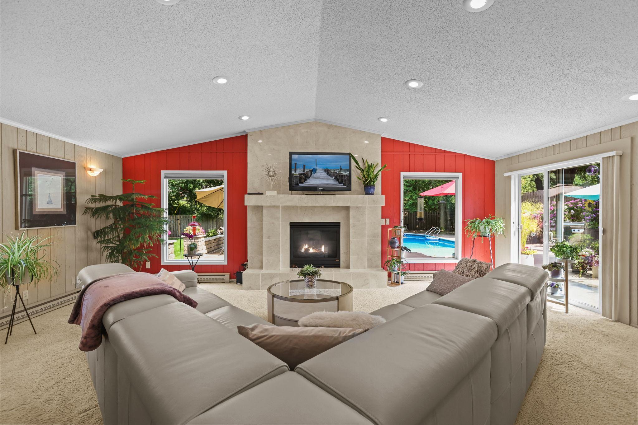 Family room with gas fireplace, vaulted ceiling, views to pool and patio