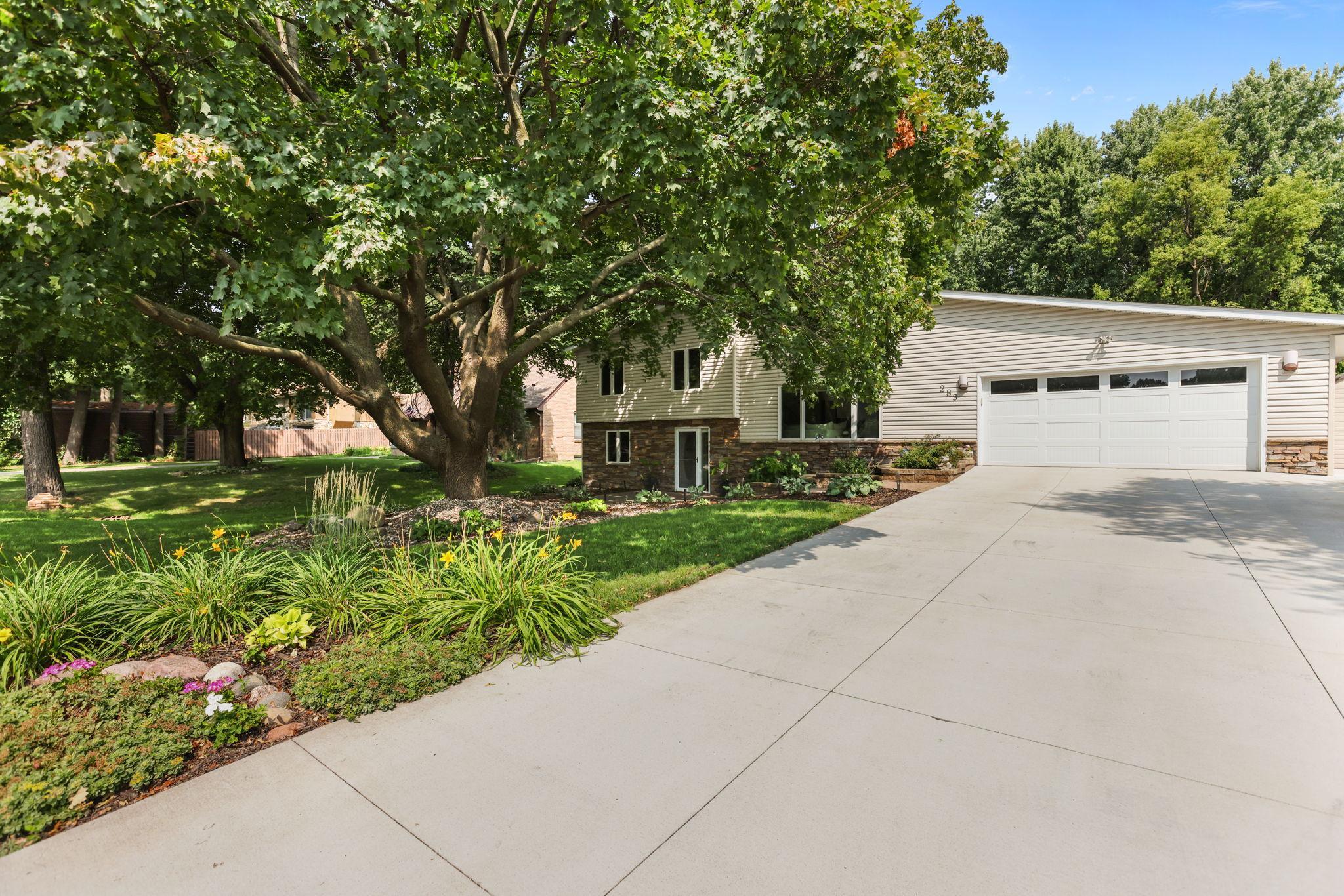 Street view front of home, concrete driveway, in-ground irrigation, perennials
