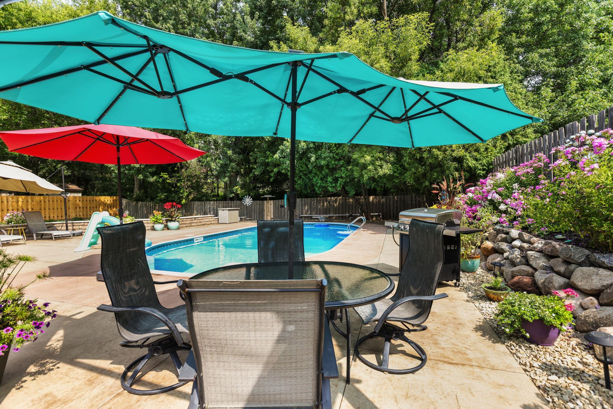 Patio dining, adjacent to pool and well established perennials