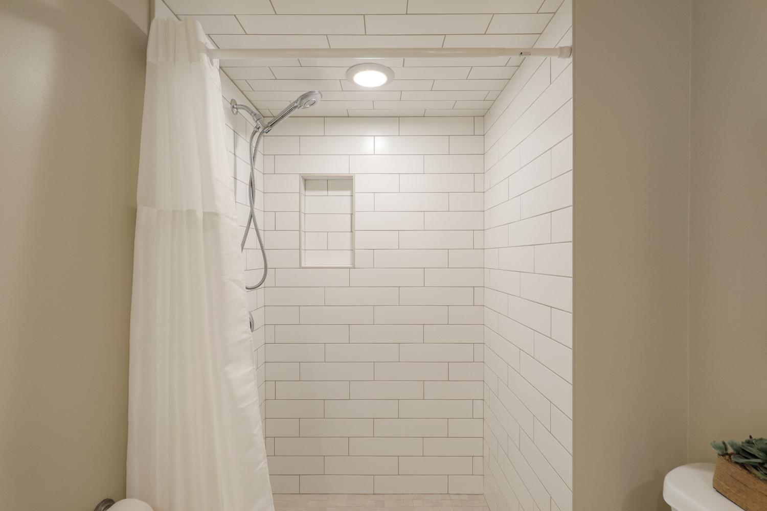 Main level bathroom with a new tiled shower