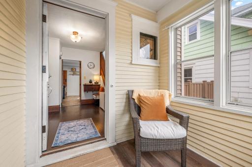 Enter through the cozy three-season porch.