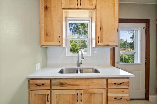 Stone countertops w/tile backsplash