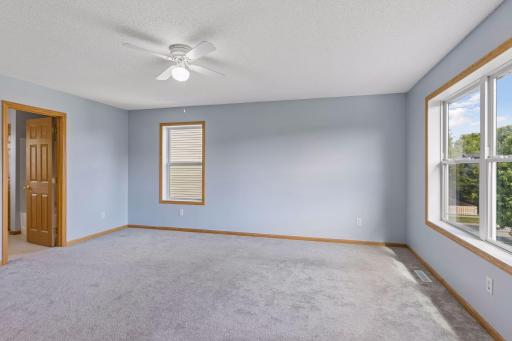 Spacious primary bedroom with abundant natural light