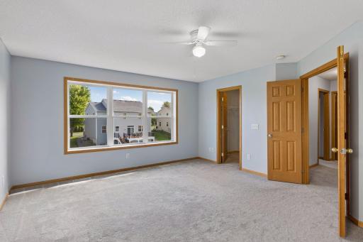 Spacious primary bedroom with abundant natural light