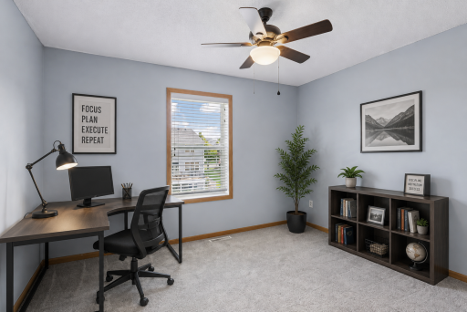 Virtually staged upper level bedroom with ceiling fan.