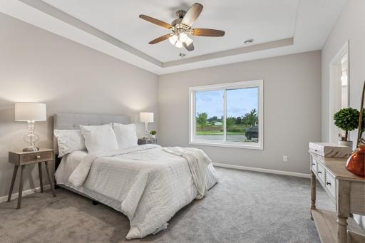 Lovely primary suite with walk-in closet and private bathroom with curbless shower Photos from similar home.
