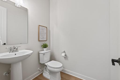 This quaint powder bathroom is thoughtfully separated from the main living areas, providing added privacy for guests and family alike.