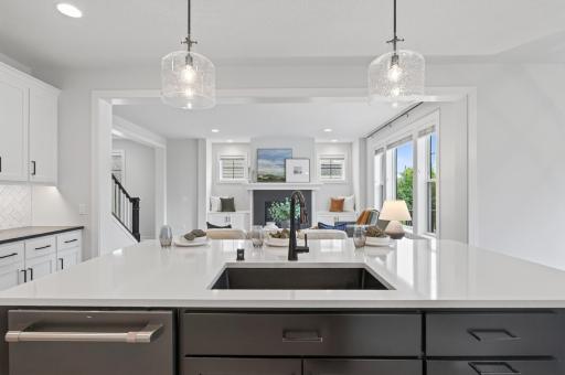 This kitchen flows seamlessly into the living room, keeping you connected with family and friends whether you're hosting a get-together or unwinding with a show during meal prep.