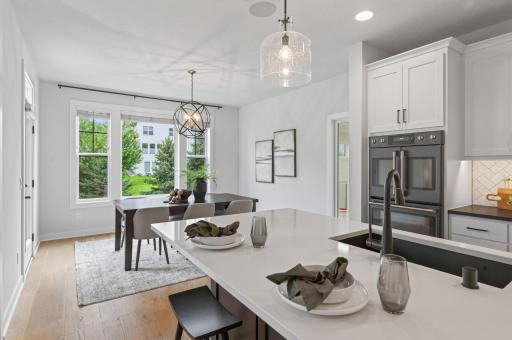 This view from the breakfast bar highlights the seamless flow into the dining room, showcasing the home's thoughtfully designed open layout.