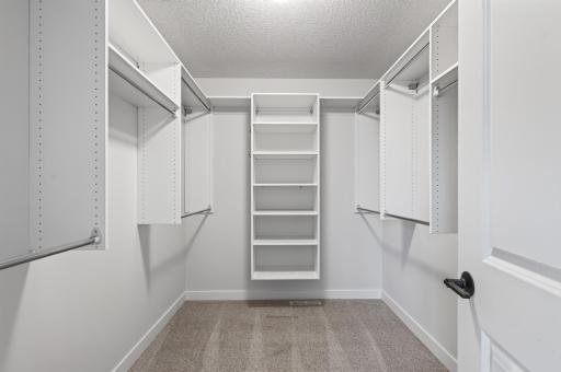 This spacious owner's suite walk-in closet comes complete with an organized clothing system, making it easy to keep everything in its place.