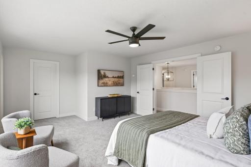 Spacious primary bedroom featuring a private walk-in closet and en-suite 3/4 bathroom.