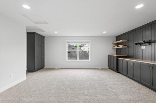 Offers tons of cabinetry for all your storage needs in this perfect bonus room. Such a great space for watching movies or creating your own gaming space!