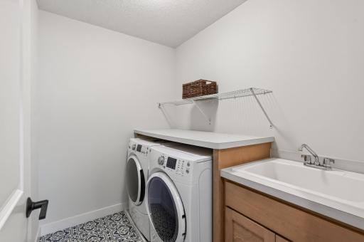Say goodbye to hauling laundry up and down stairs; this upstairs laundry room is perfectly located and includes a handy laundry sink for extra convenience.