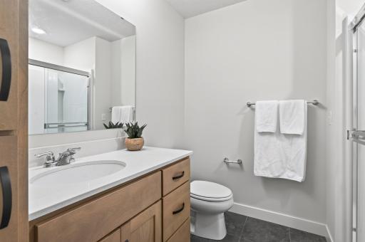With ample cabinetry space and a linen closet, this lower level 3/4 bathroom is perfect for entertaining guests or hosting an overnight stay, positioned right across from the 5th bedroom.