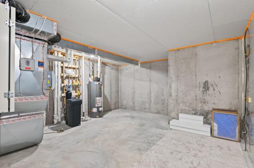 Built with solid poured foundation walls, this unfinished mechanical room includes a water softener and plenty of room for storage.