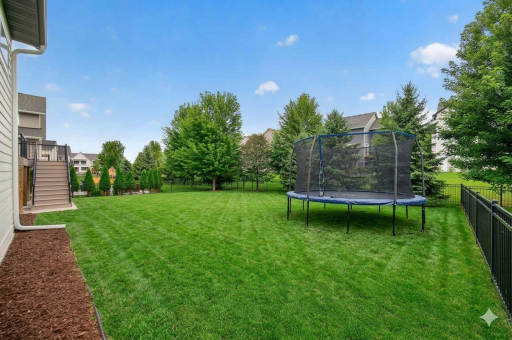 Large, fully fenced backyard with mature trees offering tons of privacy and space for a game! Virtually staged with trampoline.