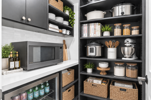 Butlerâs pantry featuring a beverage fridge, microwave, open shelving, and crisp white tile backsplash. Virtually staged**