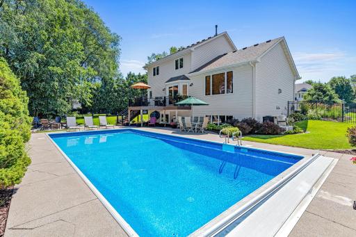Step from the maintenance-free deck to your own backyard oasis featuring an inviting in-ground pool.