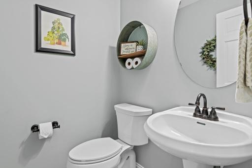 Main floor 1/2 bath tucked around the corner from the kitchen and next to the exercise room.