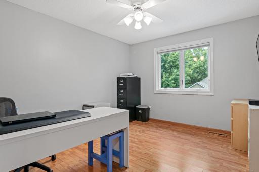 One of three bedroom located upstairs. This is currently being used as an office. Each room offers comfortable space for family, guests or personal use.