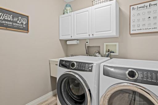 Main floor laundry with utility sink. Located next to the garage and mudroom for easy clean ups!