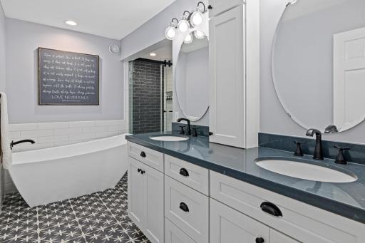 Beautifully updated owner's bath offers a fresh, modern feel. Double vanity sink for ease of getting ready with abundant storage space.