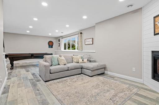 Lookout lower-level family room is filled with wonderful natural light and great views to the back.