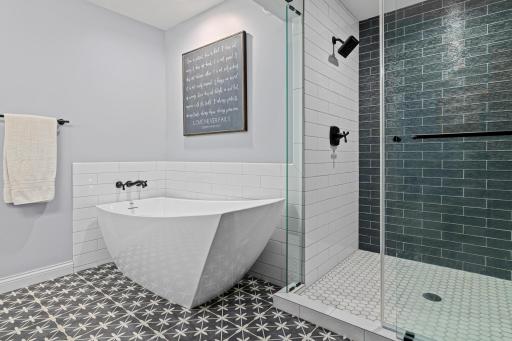 Deep soaking tub and elegant shower provide a relaxing, private retreat conveniently located within the owner's suite.