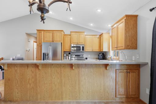 Lots of storage and natural woodwork on this large kitchen area.