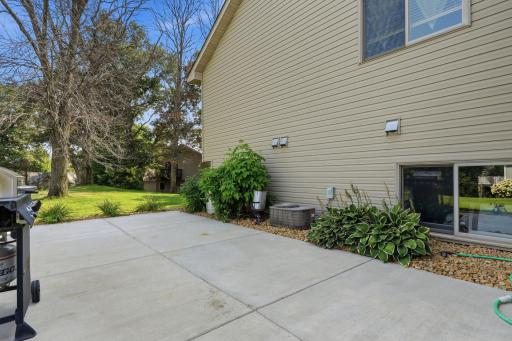Large concrete patio on side of home perfect for grilling or entertaining.