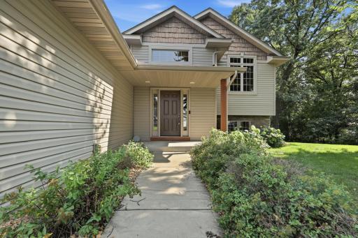 The shade from the trees and the newly updated front door welcome you in.