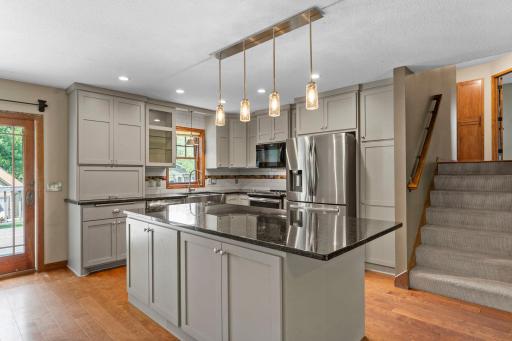 Stainless steel appliances and convenient details such as a built-in cutting board and tile backsplash!