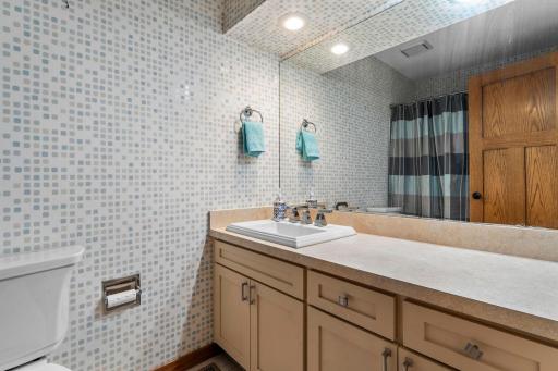 The upper-level full bath has an extended vanity for added functional counter space.