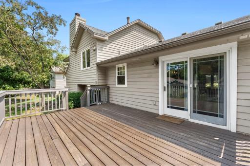 Outside, the fully fenced backyard feels established and inviting, with mature trees, landscaping, and a large deck freshly painted in 2024.