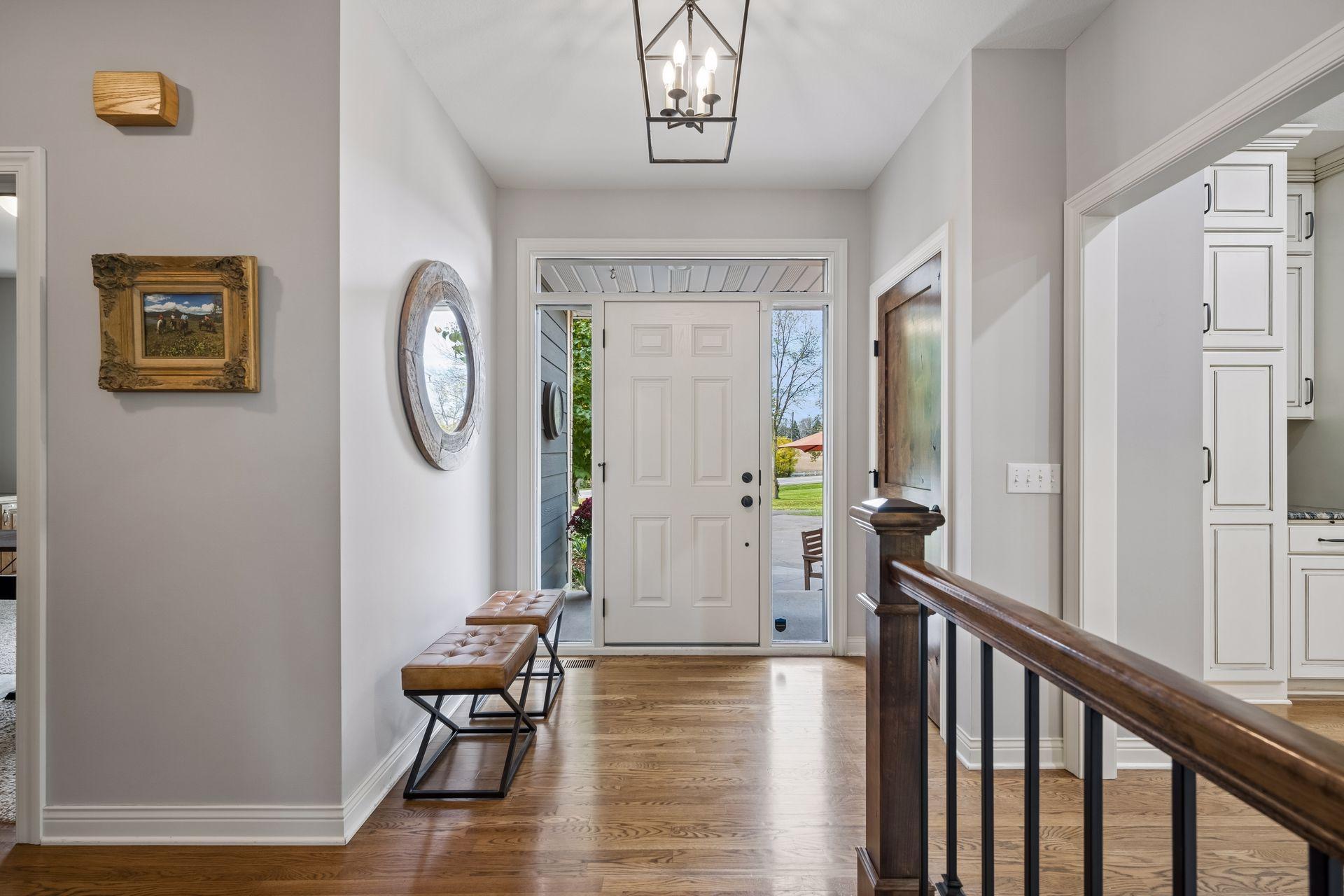 The light-filled foyer offers a warm introduction to the home’s thoughtfully arranged main level.