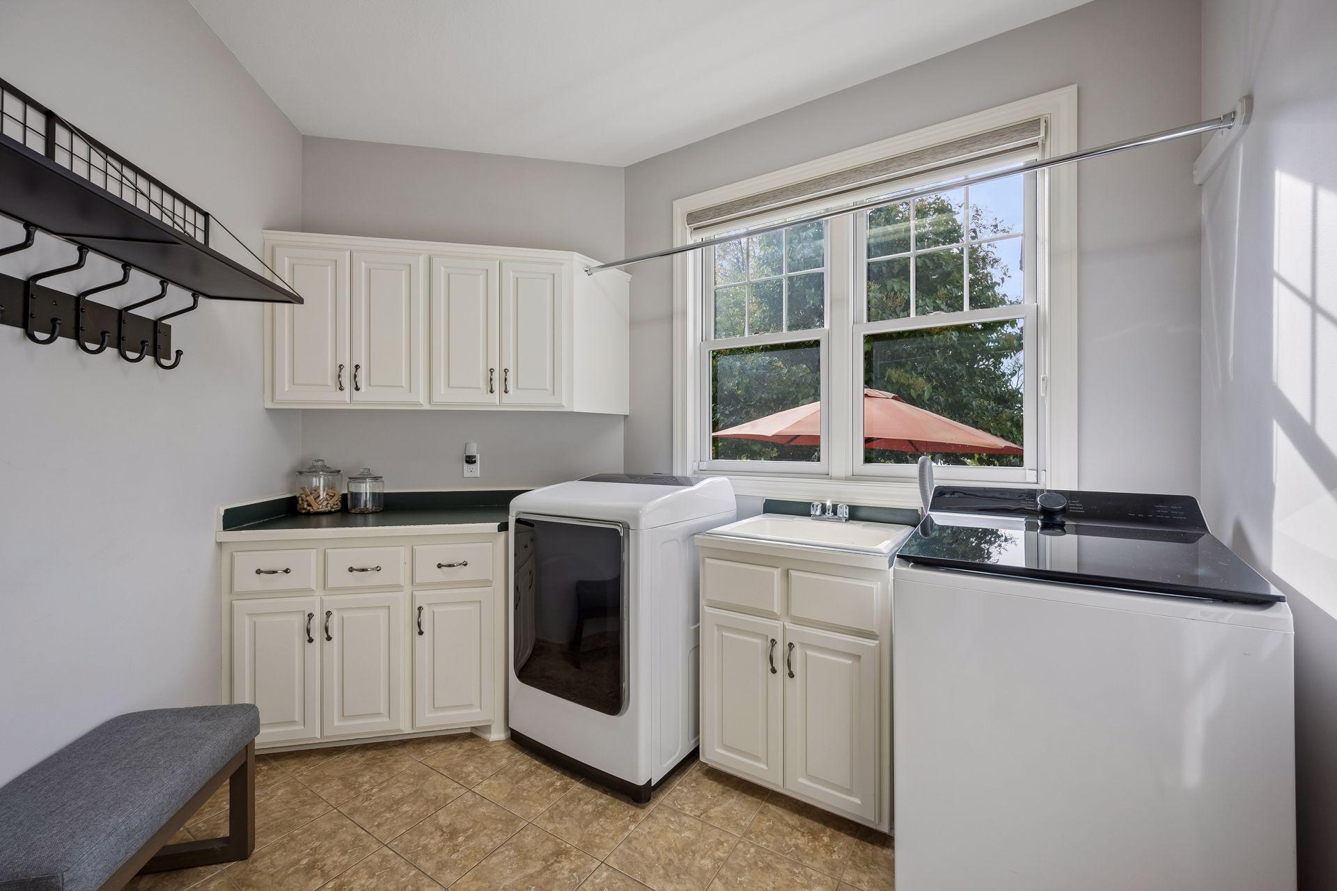 Conveniently located off the garage, the large laundry room features a generous walk-in closet that provides plenty of space for a practical everyday drop zone.