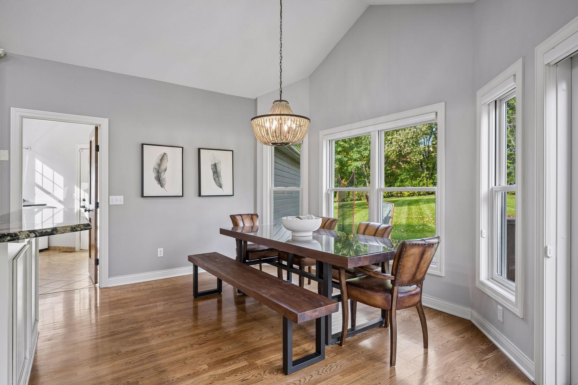 Surrounded by windows, the informal dining area enjoys peaceful views of the expansive yard.