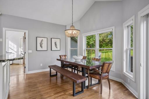 Surrounded by windows, the informal dining area enjoys peaceful views of the expansive yard.